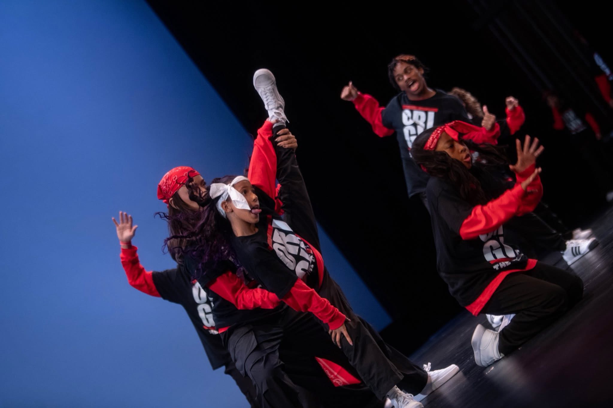 Origin crew dancers in midair during a stage performance